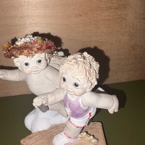 Whimsical Child Figurine Duo with Floral Accents